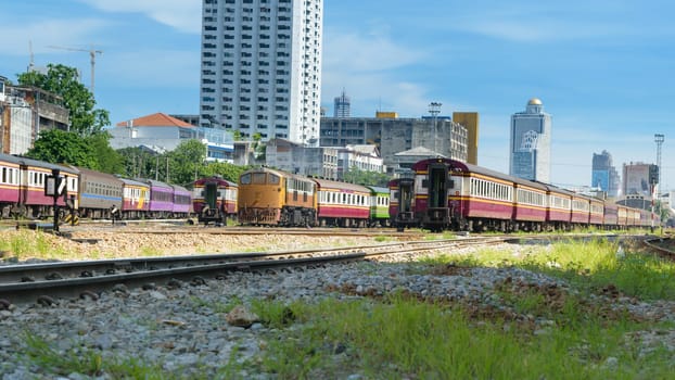 Bangkok, Thailand - August 14, 2015 : Unidentified train run on the railroad tracks. Many people in Thailand popular travel by train because it is cheaper.