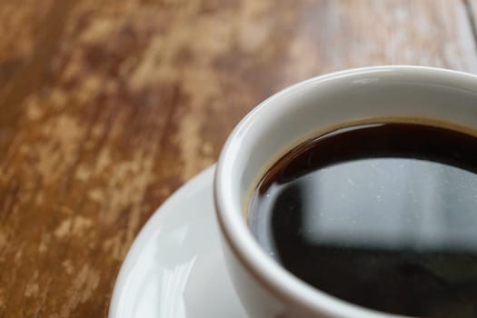 Coffee in white cup on wood table