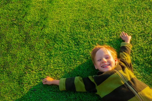 The child goes in for sports at the stadium. The boy training before playing football. banner with copy space