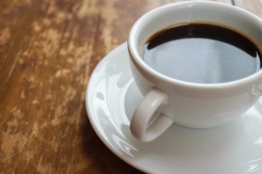 Coffee in white cup on wood table
