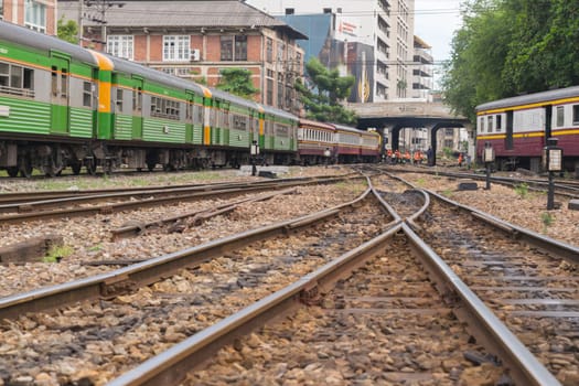 Bangkok, Thailand - September 5, 2015 : Unidentified railway train run on the railroad tracks. Many people in Thailand popular travel by train because it is cheaper.