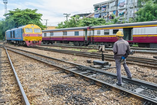 Bangkok, Thailand - September 5, 2015 : Unidentified railway employees controlling the locomotive for switching the railway before serving at State Railway of Thailand.