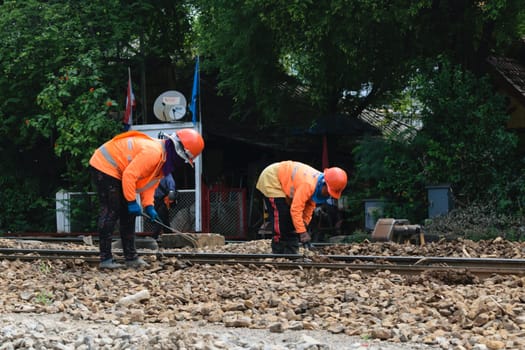Bangkok, Thailand - September 5, 2015 : Unidentified railway employees working for restoration the railroad tracks before serving at State Railway of Thailand.