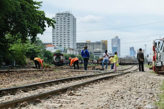 Bangkok, Thailand - September 5, 2015 : Unidentified railway employees working for restoration the railroad tracks before serving at State Railway of Thailand.