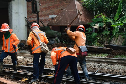 Bangkok, Thailand - September 5, 2015 : Unidentified railway employees working for restoration the railroad tracks before serving at State Railway of Thailand.