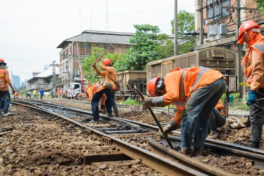 Bangkok, Thailand - September 5, 2015 : Unidentified railway employees working for restoration the railroad tracks before serving at State Railway of Thailand.