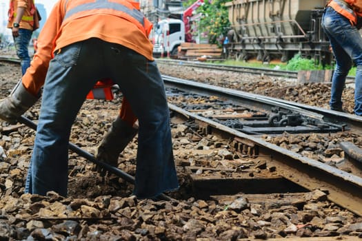 Bangkok, Thailand - September 5, 2015 : Unidentified railway employees working for restoration the railroad tracks before serving at State Railway of Thailand.