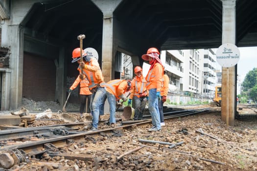 Bangkok, Thailand - September 5, 2015 : Unidentified railway employees working for restoration the railroad tracks before serving at State Railway of Thailand.
