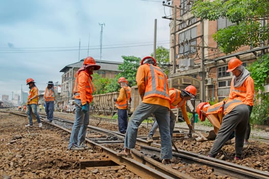 Bangkok, Thailand - September 6, 2015 : Unidentified railway employees working for restoration the railway before departure at State Railway of Thailand.