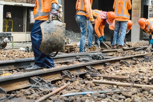 Bangkok, Thailand - September 5, 2015 : Unidentified railway employees working for restoration the railroad tracks before serving at State Railway of Thailand.