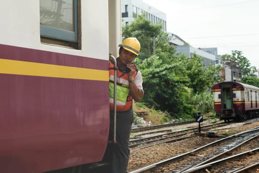 Bangkok, Thailand - September 5, 2015 : Unidentified railway employees controlling the locomotive for switching the railway before serving at State Railway of Thailand.