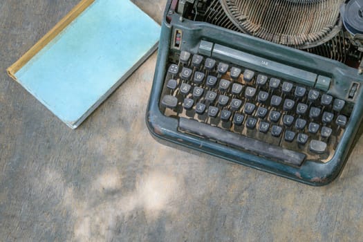 Vintage typewriter and a notebook on a wood table