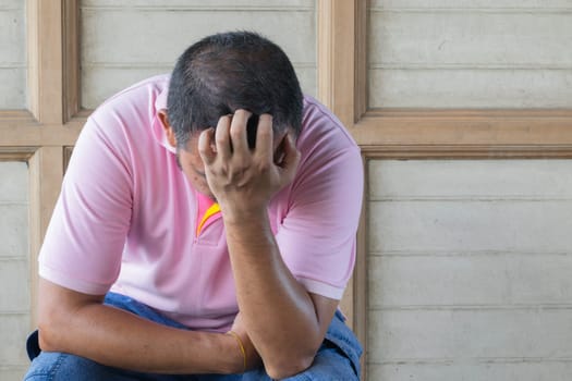 Anxious asian man feeling sadness and stress sitting on the chair