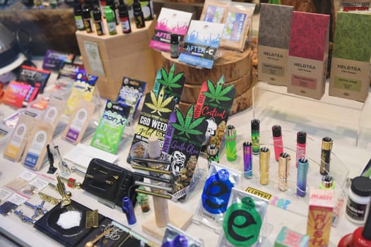 AMSTERDAM, THE NETHERLANDS - APRIL 15, 2019: Shop window with cookies, candies, oil,tea of cannabis as a souvenir in the showcase of store