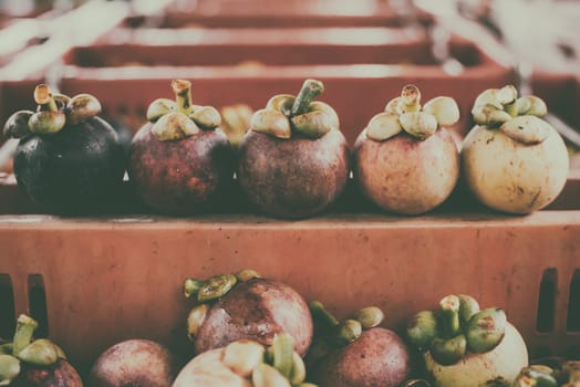 Mangosteen on a wood table is a queen of fruit in Thailand and asia fruit have a sweet can buy at Thai street food and fruit market