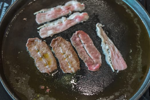 Grilled raw meat beef and pork (barbeque, bbq) a food cooking on wagyu grill in BBQ. yakiniku grill buffet restaurant