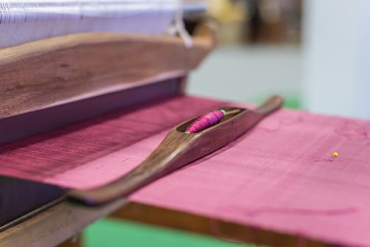Traditional loom machine vintage style is tool for weave of making Thai silk from cocoon use by homemade in Laos and Thailand