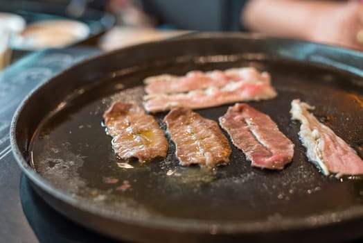 Grilled raw meat beef and pork (barbeque, bbq) a food cooking on wagyu grill in BBQ. yakiniku grill buffet restaurant