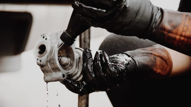 Car mechanic or serviceman disassembled car dirty engine for cleaning fuel injection and air flow system engine parts for fix and repair problem at car garage or repair shop
