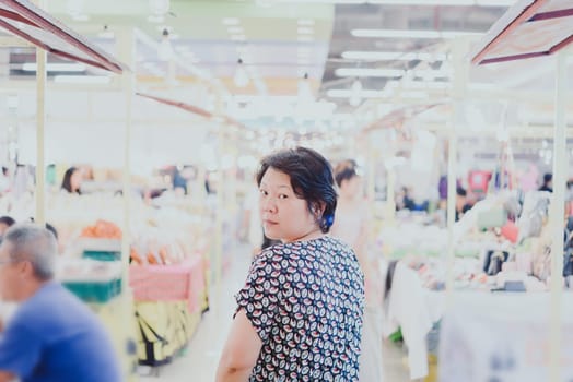 Woman shopping at Thai street food market vintage style can buy food vegetable and fruit in cheap price.