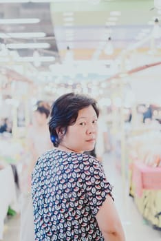 Woman shopping at Thai street food market vintage style can buy food vegetable and fruit in cheap price.