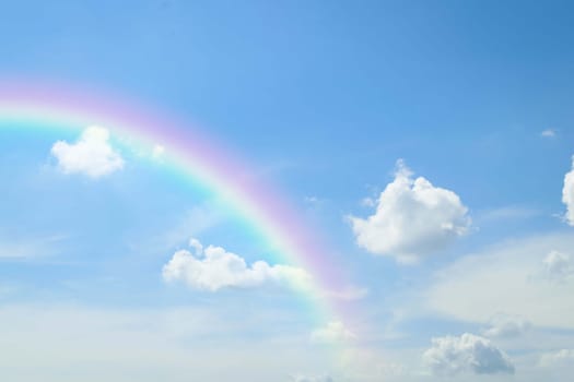 Cloudscape rainbow of natural sky with blue sky and white clouds and colorful rainbow in the sky use for wallpaper background