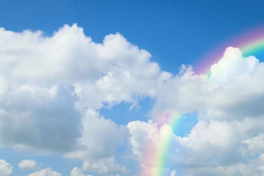 Cloudscape rainbow of natural sky with blue sky and white clouds and colorful rainbow in the sky use for wallpaper background