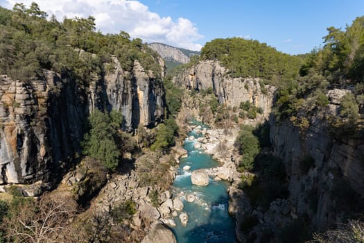 Mountain gorge and bright blue stream. Landscape
