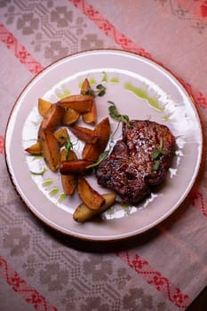 Beautiful restaurant dish golden potatoes and juicy meat, beautiful food photo,