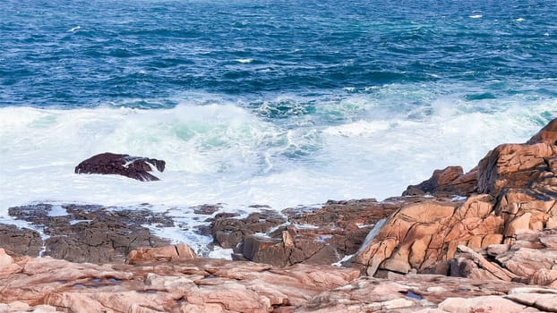 Rugged coastal cliffs with crashing waves in a scenic ocean view.