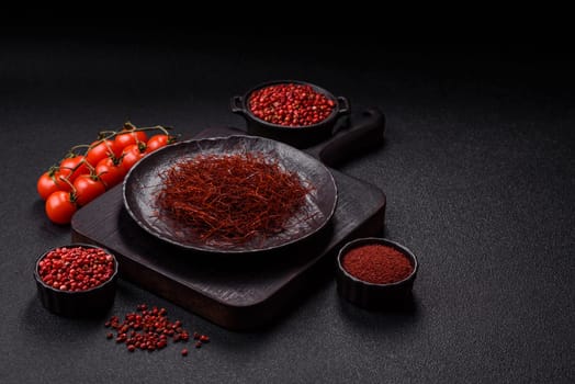 Red thin hot chili threads on a dark background. For decorating Asian dishes