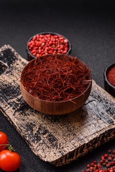 Red thin hot chili threads on a dark background. For decorating Asian dishes