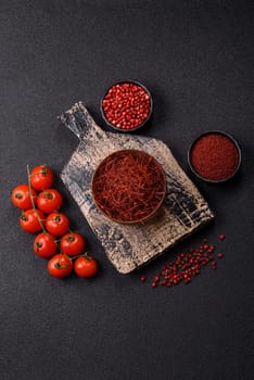 Red thin hot chili threads on a dark background. For decorating Asian dishes