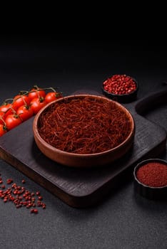 Red thin hot chili threads on a dark background. For decorating Asian dishes