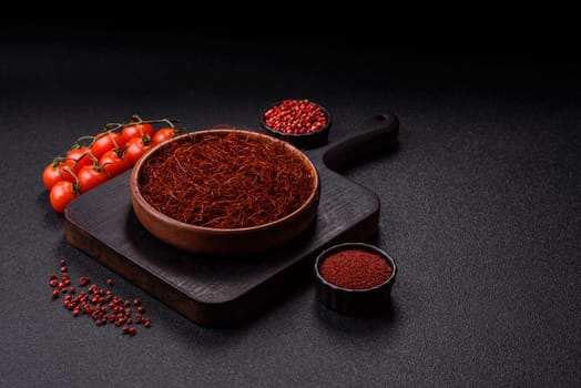 Red thin hot chili threads on a dark background. For decorating Asian dishes