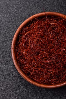Red thin hot chili threads on a dark background. For decorating Asian dishes