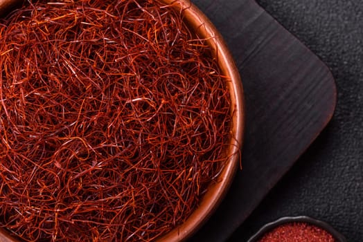 Red thin hot chili threads on a dark background. For decorating Asian dishes