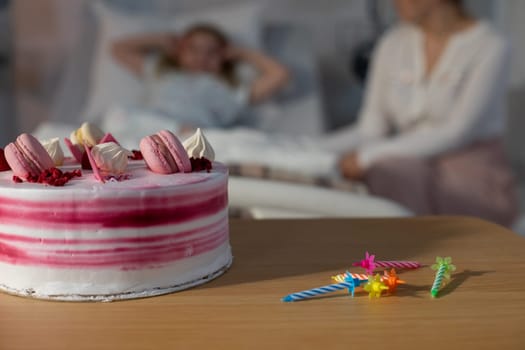 A beautifully colorful cake placed beside a hospital bed, representing both care and celebration in life