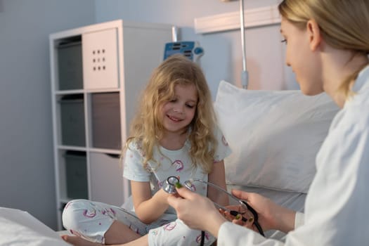 A caring nurse interacts with a young patient in a hospital setting, promoting a comforting environment.