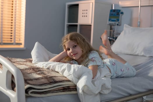 In a hospital room, a young girl rests peacefully in her bed, radiating hope and comfort amidst the medical care