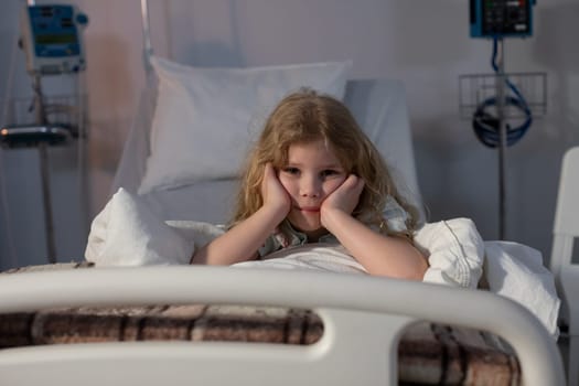 A worried child lies in a hospital bed, feeling uneasy and alone amidst the unfamiliar, sterile medical surroundings