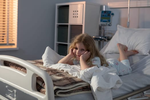 A young child is lying in a hospital bed, thoughtfully reflecting on their entire health journey so far