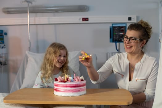 A heartwarming and truly joyful moment of celebration featuring a child and a delicious cake in a hospital setting