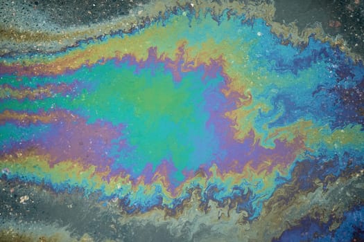 Brightly colored oil slick creating a striking abstract pattern that captivates the imagination