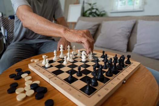 A father making a strategic move on a chessboard during a game with his son, illustrating family bonding through thoughtful play.