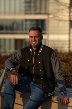 Portrait of a smiling bearded man outdoors at sunset