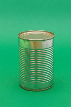 Unopened Tin Can with Blank Edge on Green Background. Canned Food. Aluminum Can for Safe and Long Term Storage of Food. Steel Sealed Food Storage Container