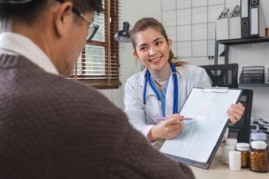 A female doctor is giving advice on diseases and medicine to an elderly male patient. Age 60, concept of health examination and health care.