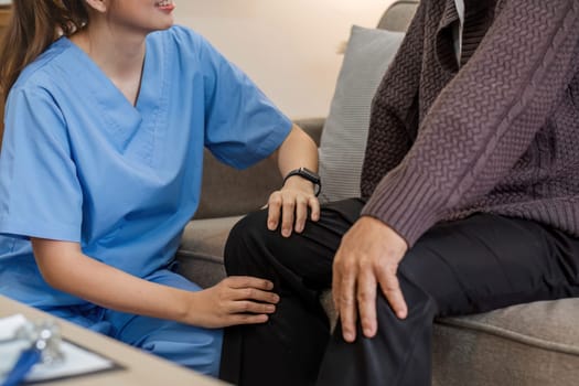 Caregivers assist elderly man with check-ups and physical therapy while he is recover at home..