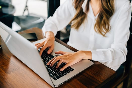 Asian young business woman lifestyle using laptop computer at cafe coffee shop, Happy beautiful freelancer typing keyboard on laptop, working online outside office